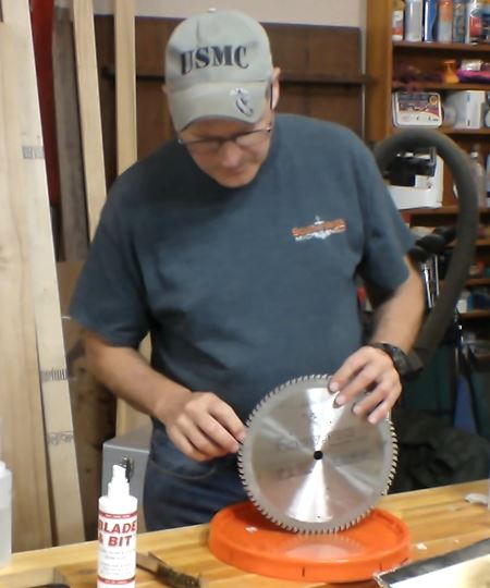 Man with a cleaned saw blade